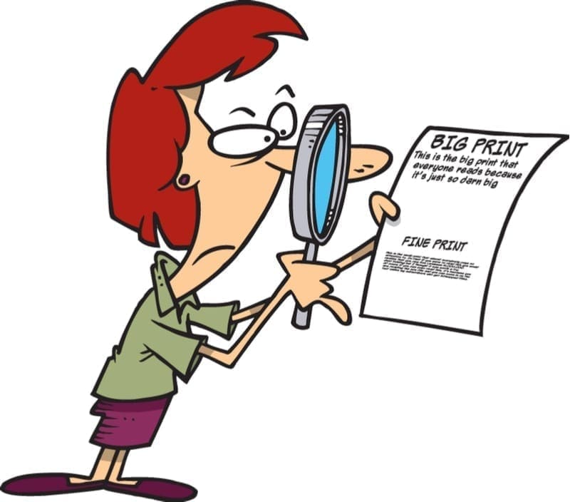 Woman looking into a magnifying glass onto a piece of paper that says the fine print