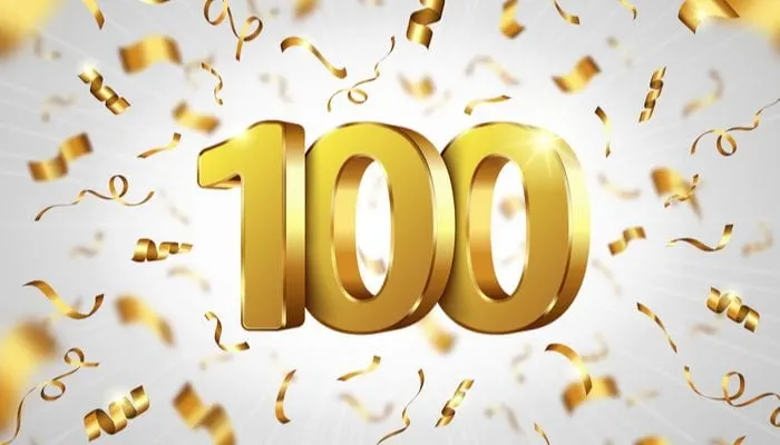 Gold 100 lettering that is computer generated with confetti to symbolize the 100 percent commission split