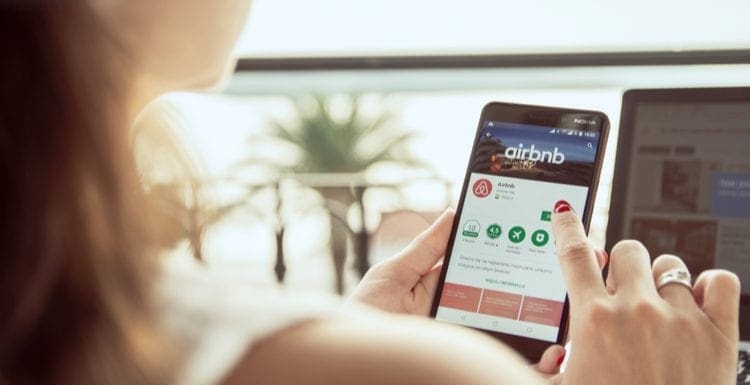 As an image for a piece on Airbnb Login problems,Woman is installing Airbnb application on Nokia smartphone. Airbnb is an online marketplace and hospitality service, enabling people to lease or rent lodging