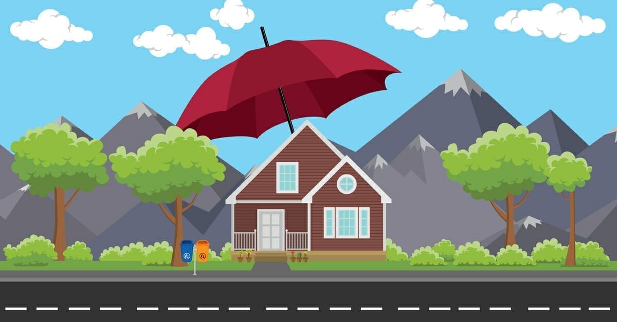 A simple mountain home with nice landscaping in the background covered by a red umbrella