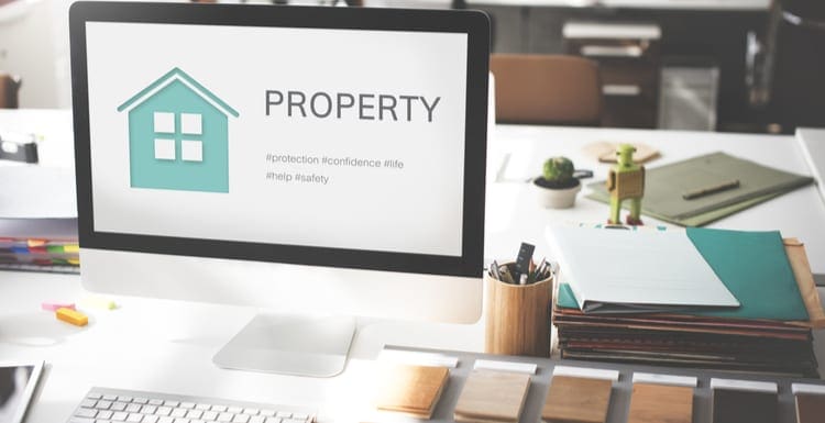 As a featured image for a piece on property management software companies, A photo with a graphical green house on it along with a little wooden robot