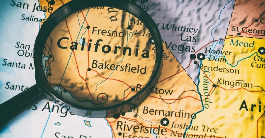 magnifying glass above the word "california" as a featured image for a piece on how to get a real estate license in California