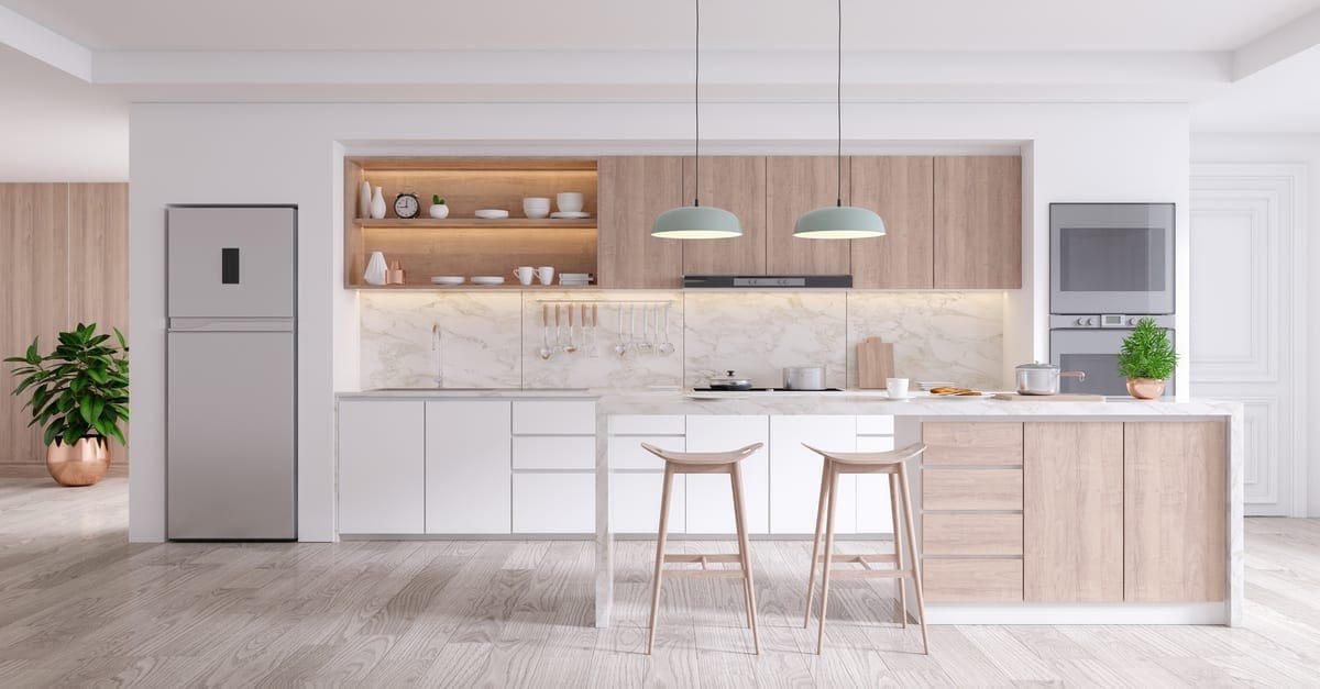 A modern kitchen with solid surface kitchen countertops and a white flat cabinet structure with some hanging lights and a nice island with stools