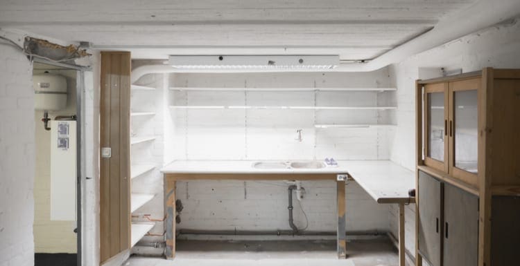 As the featured image for a piece on workbench plans, Garage Workshop in an old building, empty shelves