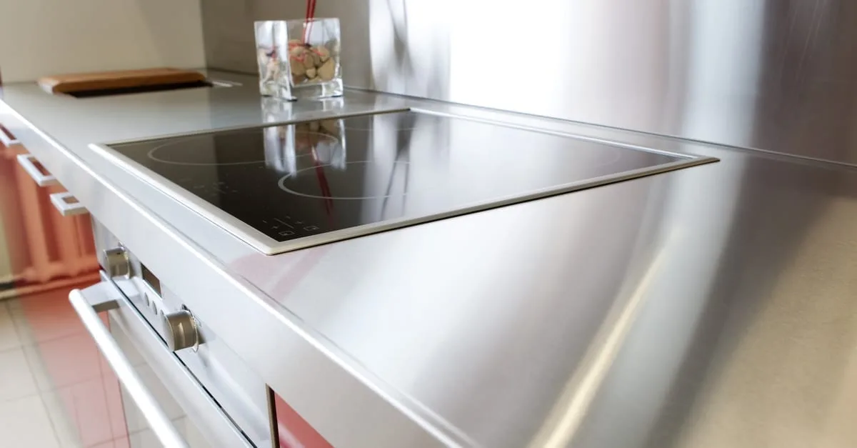 A close up of a residential kitchen with stainless steel countertops
