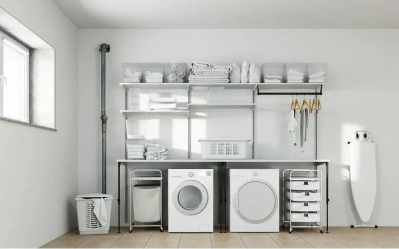 Image of an unfinished basement idea with a laundry station featuring a washer and dryer in the corner of the room