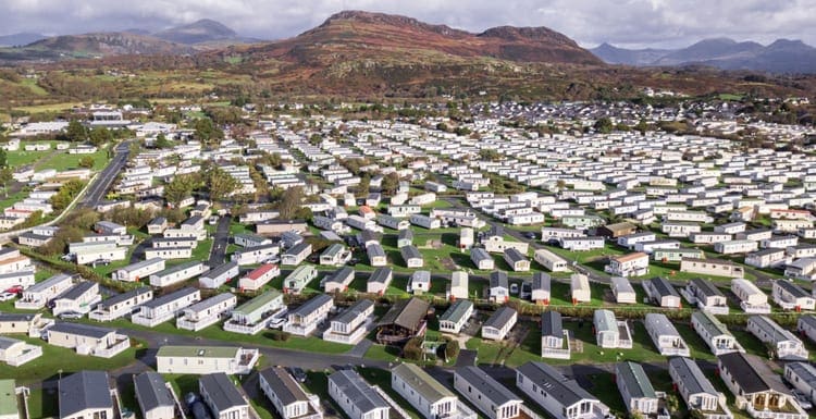 As a featured image for a piece on how to find mobile home parks for sale, caravan and camping, static home aerial view. Porthmadog holiday park taken from the air by a drone.