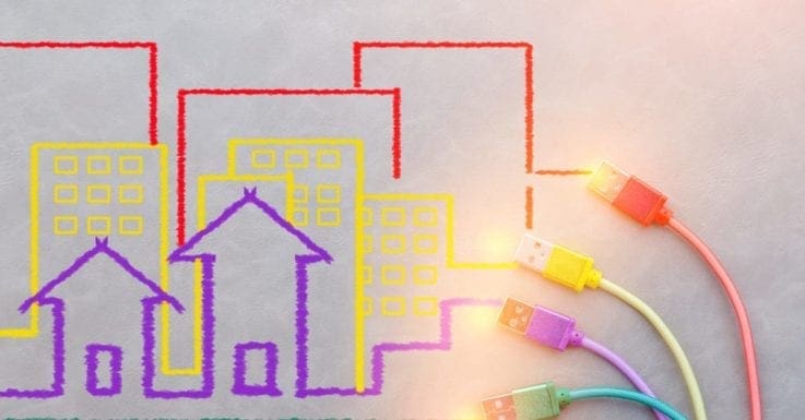 A group of red, yellow, and purple houses and buildings and usb cords as the featured image for a piece on real estate software