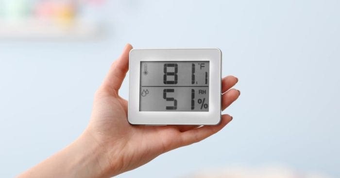 Woman checking temperature and humidity in baby room