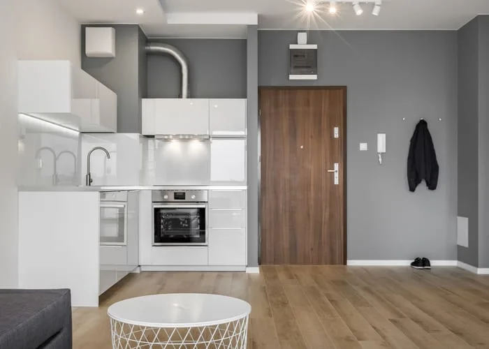 Gray and white apartment with small open kitchen
