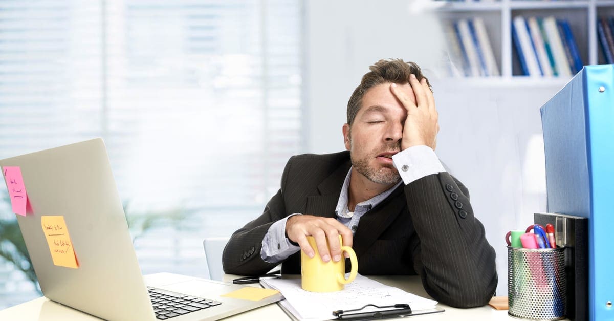 tired and frustrated businessman desperate face expression suffering stress worried with headache at computer desk heavy work load overwhelmed and stressed in exhausted office worker concept