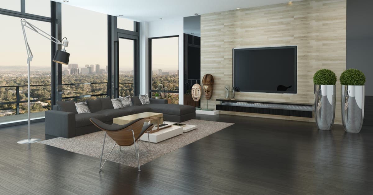 Spacious modern living room with dark grey and white decor overlooking the city through panoramic floor-to-ceiling windows. 3d Rendering.
