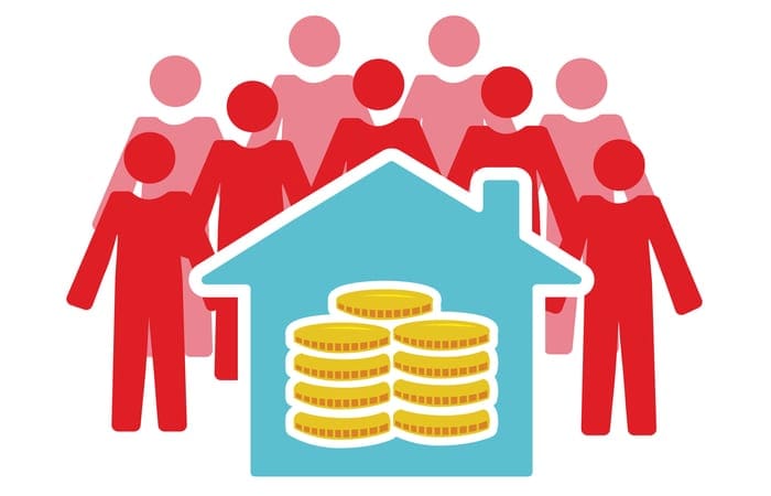 Vector image of people around a house containing money as an image for a piece on real estate crowdfunding