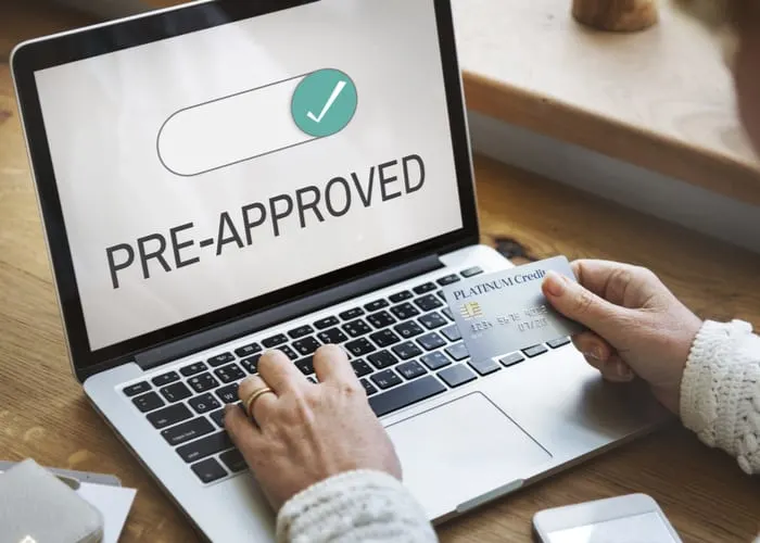 Laptop with the words "pre-approved" below a green checkmark as the featured image for a piece on how long does a mortgage pre approval letter last
