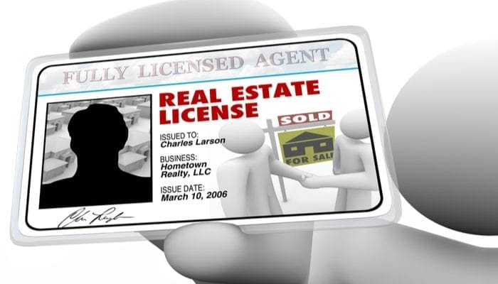 A real estate agent holds a laminated license proving he is certified and licensed by the proper authorities to do business in buying or selling property for you