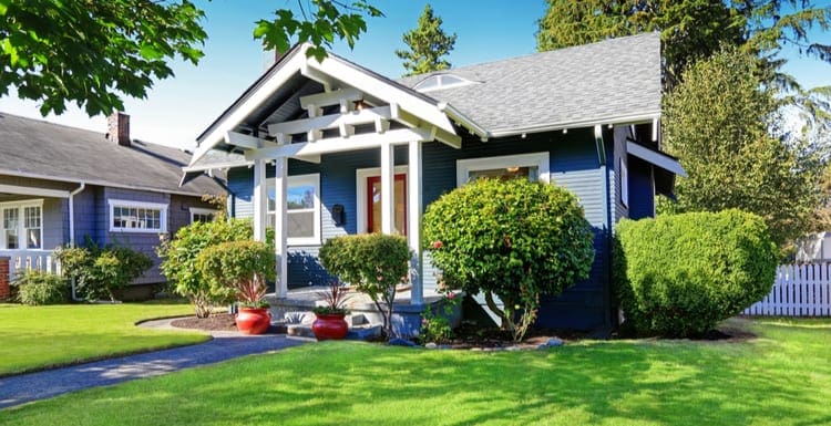 As an image for a piece on states with no property tax, simple house exterior with tile roof. Front porch with curb appeal