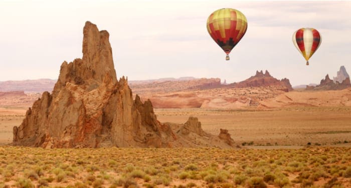 Hot Air Balloon Flying Over New Mexico Desert Landscape as an image for a piece on the states without property tax