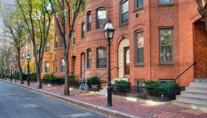 Boston townhouse. Brick apartment buildings and tree-lined street in Back Bay, Boston. Elegant streetscape as an image for a piece on states with no property tax