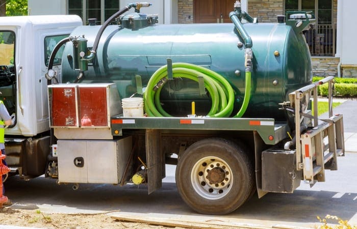 As an image for a piece on septic tank pumping near me, a photo of a portable restroom cleaning septic truck sewer of powerful professional pumping machine