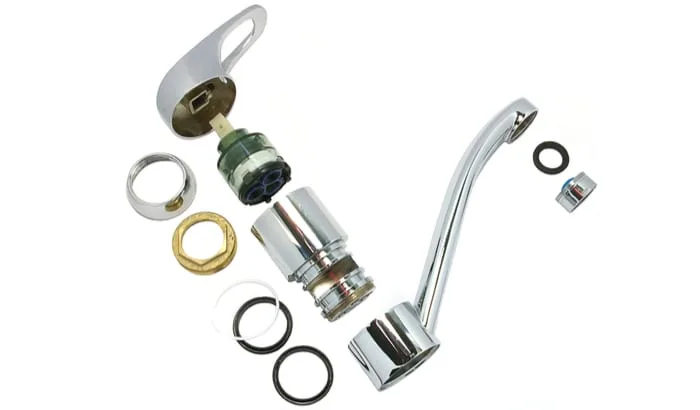 As an image for a piece on low water pressure in kitchen sink, parts of single lever kitchen faucet on the white background