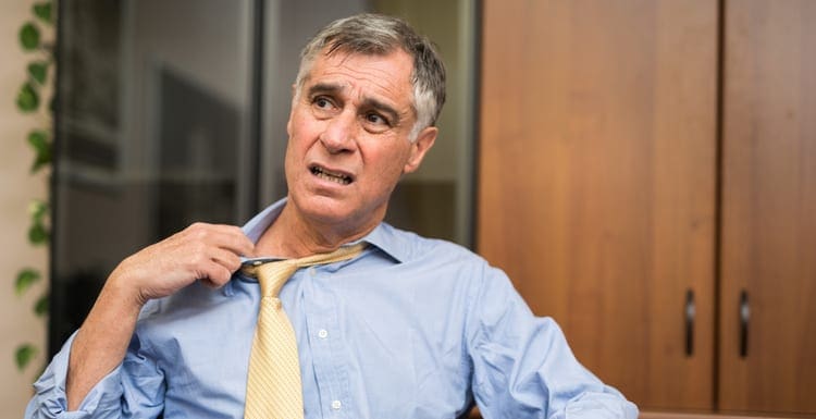 Business man sweating in his office because of a broken ac unit