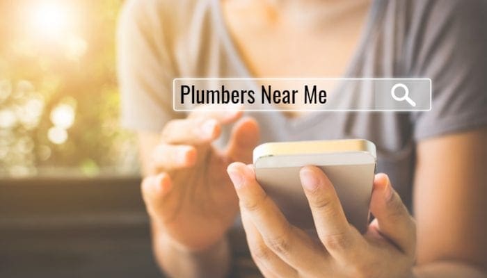 To find plumbers near me, Women use smartphones to find what they are interested in. Searching information data on internet networking concept