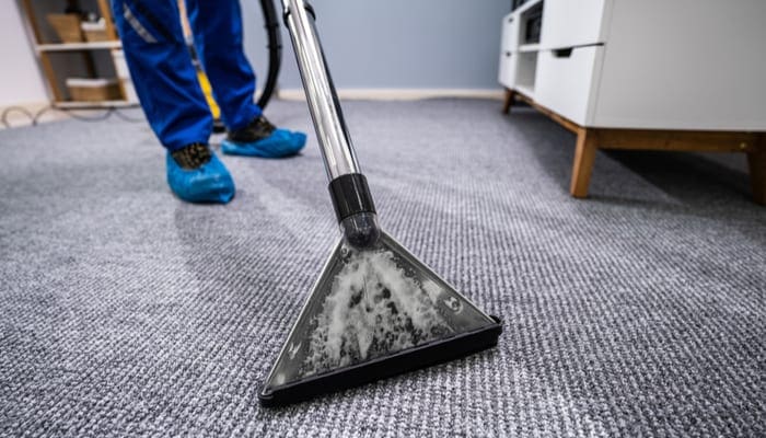 Close-up Of A Cleaning Carpet With Vacuum Cleaner