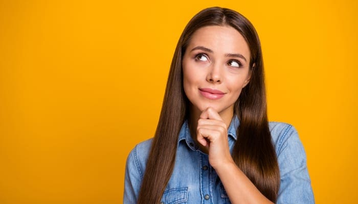 Portrait of positive cheerful girl look copyspace think thoughts about perfect weekend touch chin hands wear casual style clothing isolated over bright color background as an image for a piece on should you use the ce shop