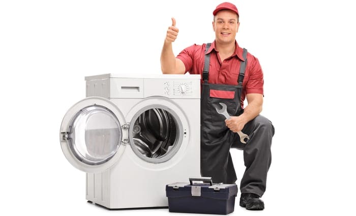 Worker repairing broken washing machine and giving thumb up isolated on white background