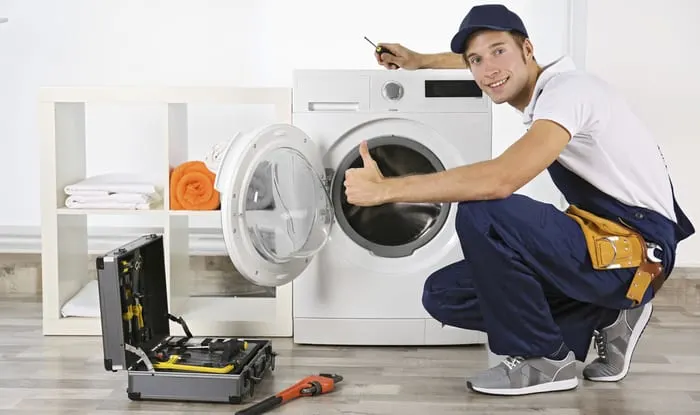 A plumber repairing washing machine