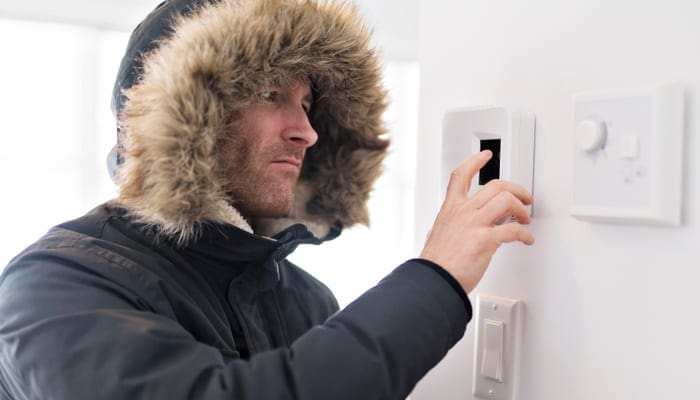 Man With Warm Clothing Feeling The Cold Inside House because he found his ac leaking water