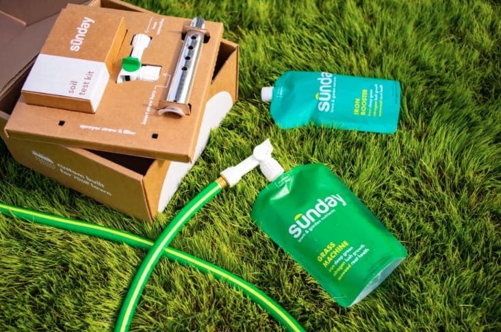 sunday lawn care review with a garden hose attached to one of the products application bags