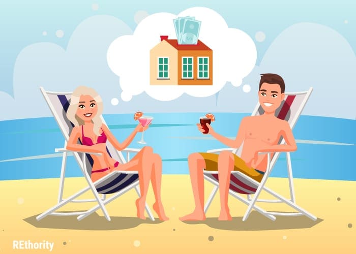 Two people lounging on a beach because they bought investment property