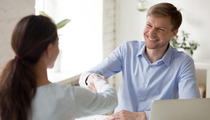 Successful negotiations secure deal. Insurance, real estate agent, financial advisor, bank interview with client. Startup investor business meeting concept. Smiling man shake hands with business woman