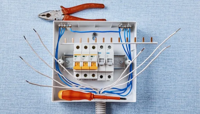 Installing of the household electrical panel. Circuit breakers are housed in a breaker box. Overcurrent protection in AC power systems. Electrical consumer unit installation. Din rail mounting.