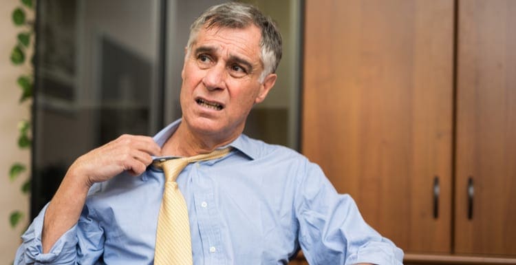 Businessman sweating in his office because his ac wont turn on