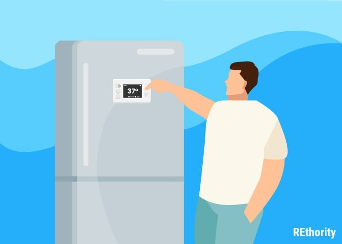 Man standing alongside a fridge setting the fridge to 37 degrees farenheit