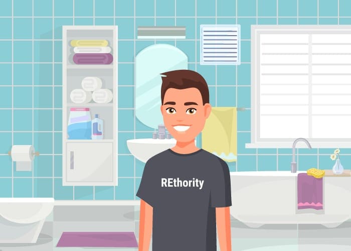 Guy in a rethority shirt standing in front of the best bathroom exhaust fan