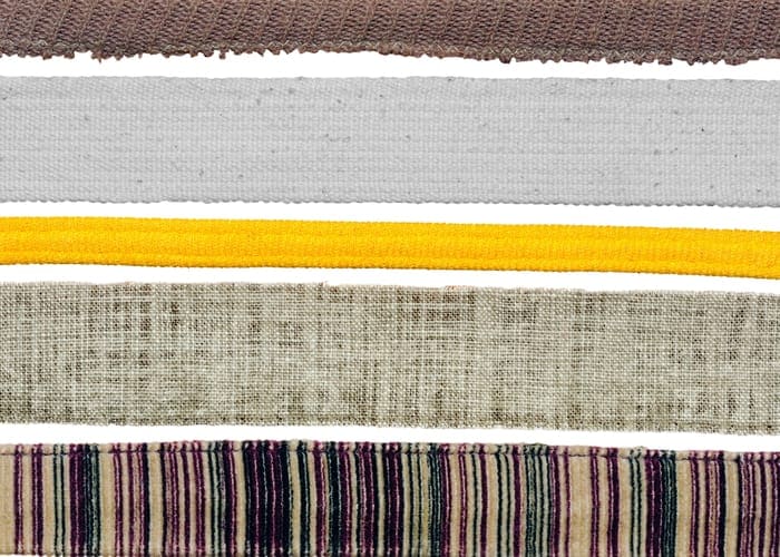 Strips of fabric in various colors against simple white background
