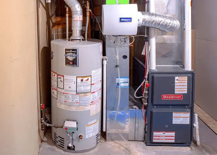 An image of a water heater in a utility room next to other household appliances