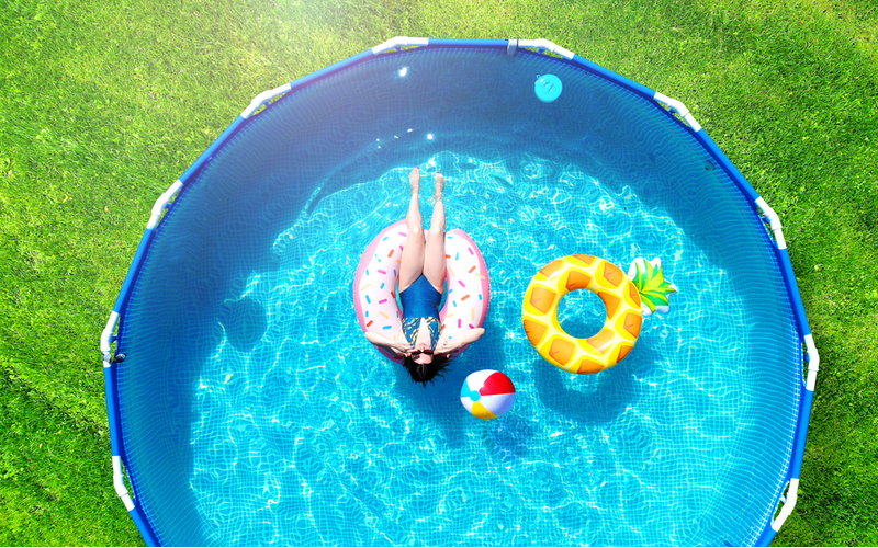Image of an Asian woman floating on a donut floatie for a piece on how to level ground for a pool