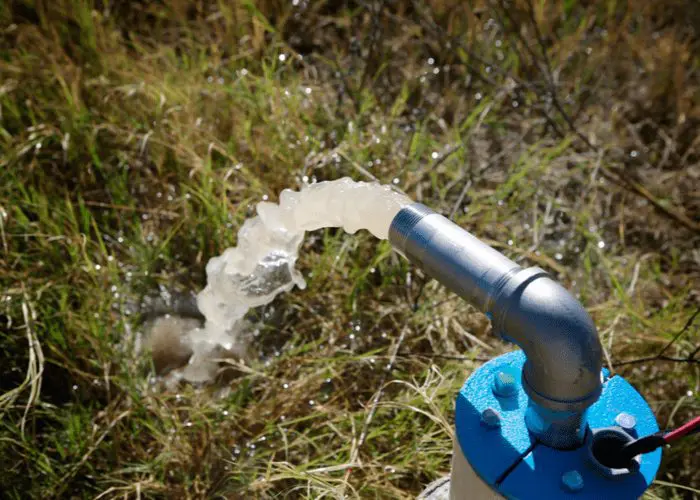 As an image to illustrate how to prime a well pump, a pump spraying out water from a cast iron pipe