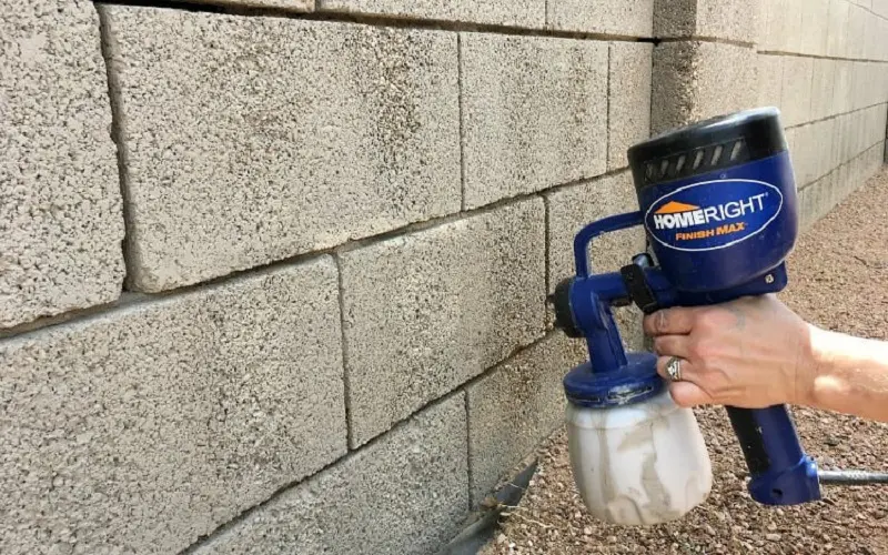 Apply a thin coat of either concrete primer or concrete sealer to the wall