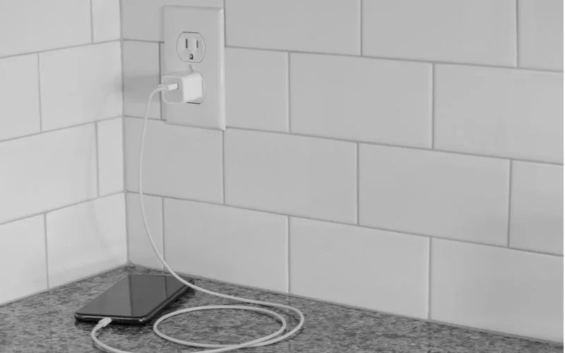 Image of a phone plugged into an outlet not working in the kitchen
