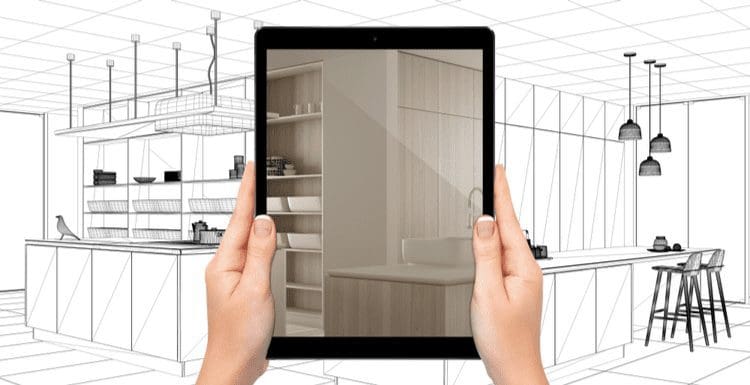 Person holding up an ipad and using the room designer app to turn a blueprint into a real-life vision concept