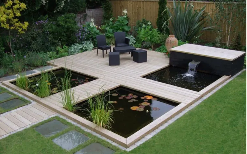 Modern zen garden with a koi pond and waterfall for a piece on landscaping ideas