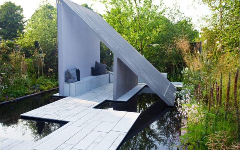 Lean-to roof slats above a floating patio deck and koi pond