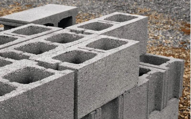 Pile of cinderblock sitting on a piece of land in preparation to build a cinderblock house