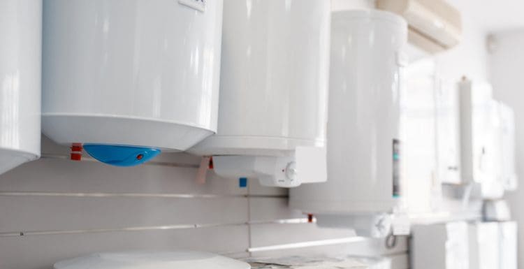 A number of water heaters mounted on a wall from the best water heater brands in a close-up shot