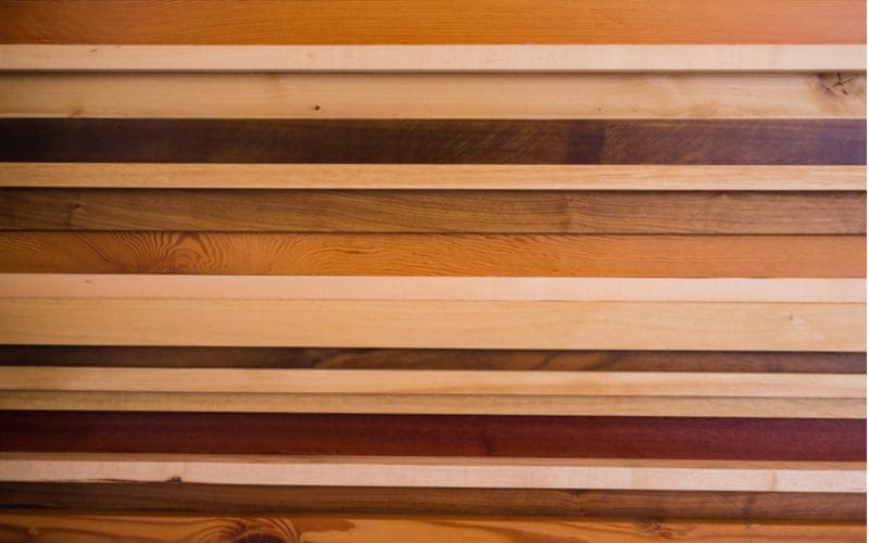 A bunch of Luan wood boards in various colors stacked on top of one another
